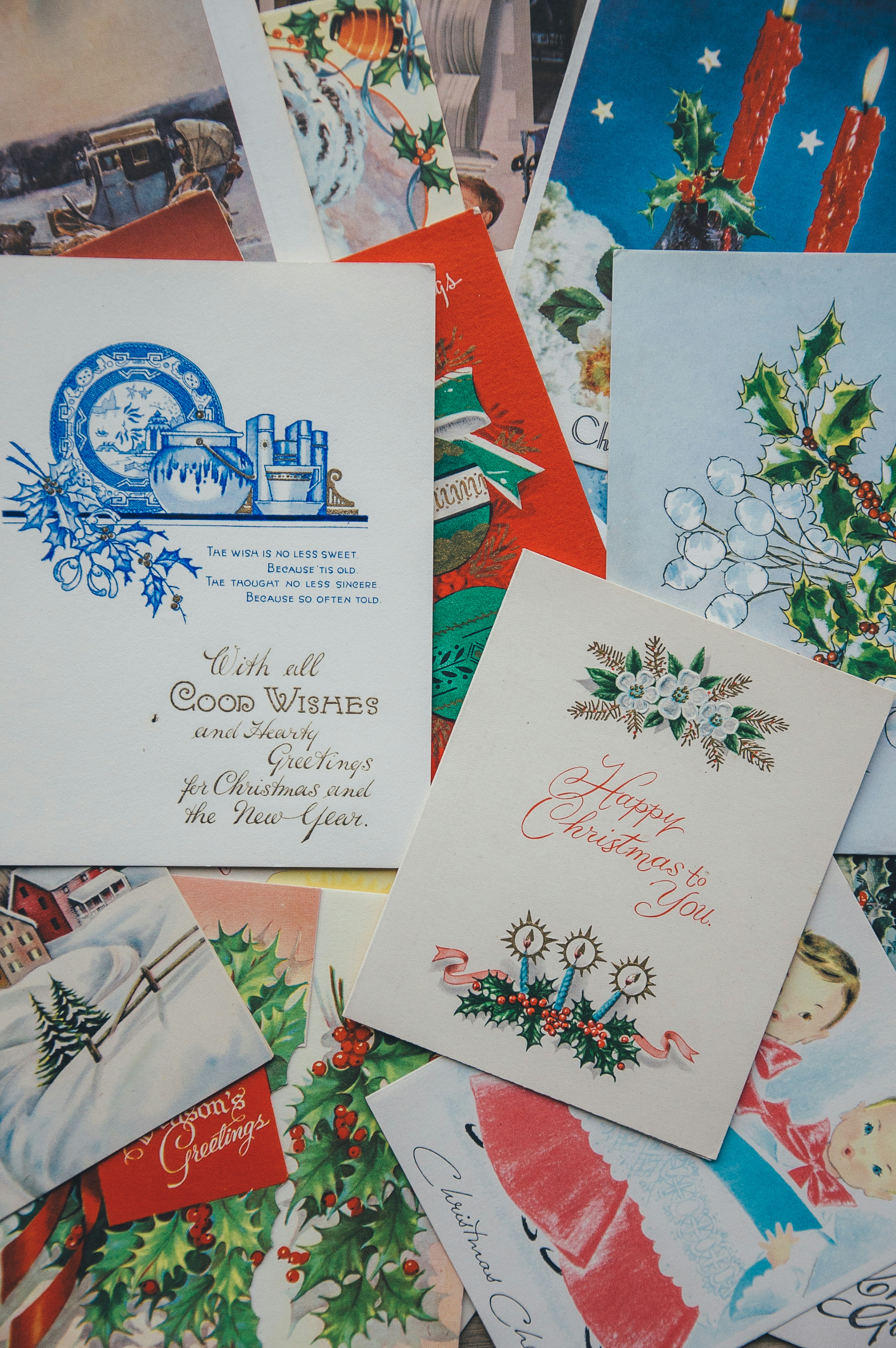 An image showing multiple Christmas cards with Christmas themed designs such as Christmas trees, snowmen, and candles. - wallpaper image