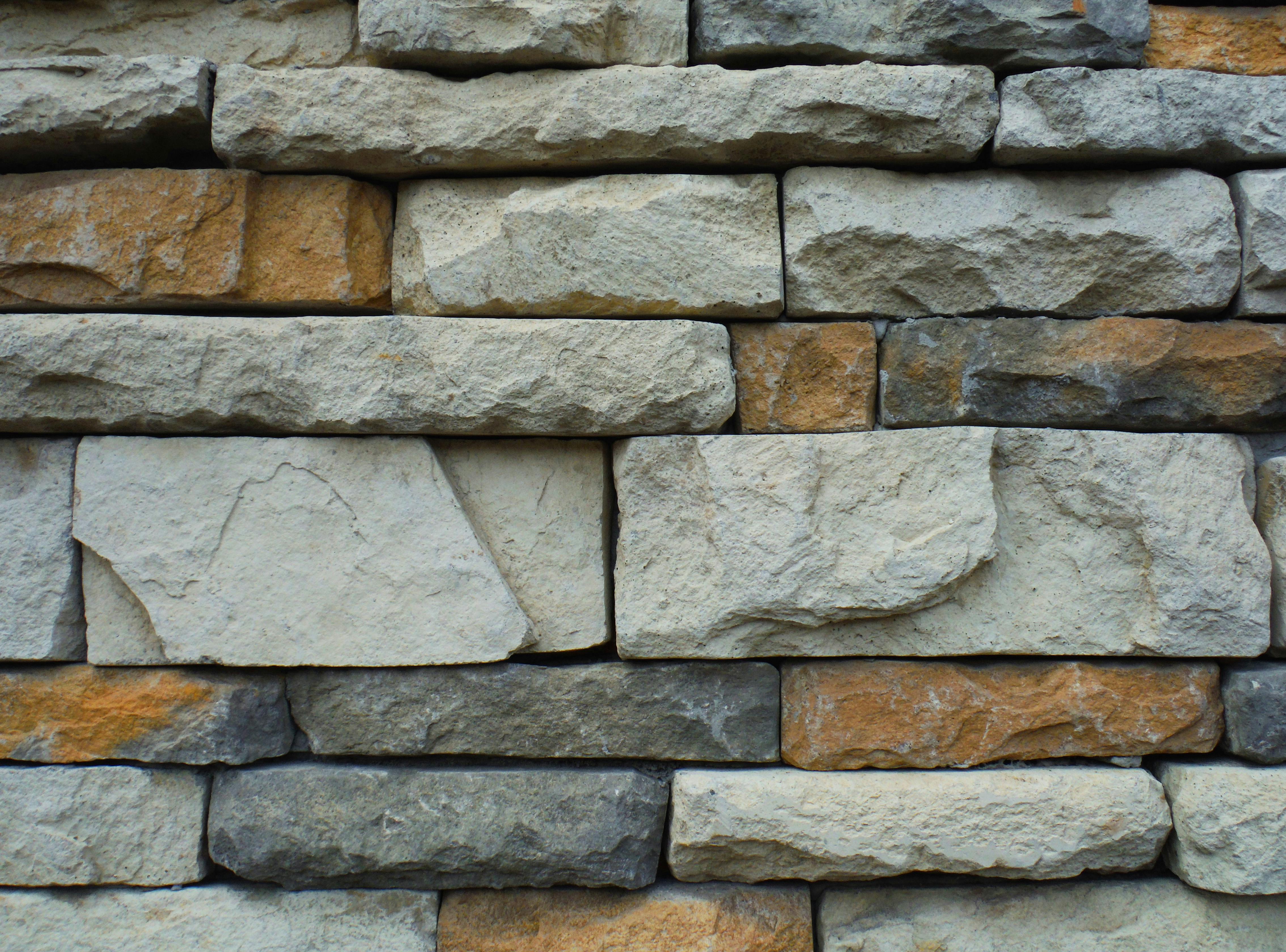 This is a wall made of gray, white and brown stones. - free wallpaper image