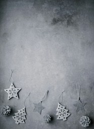 There are some Christmas ornaments, including stars, Christmas trees and pine cones, on a gray background. - wallpaper image