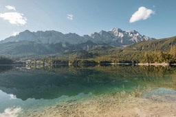 A beautiful and peaceful scenery with a clear blue lake surrounded by mountains, the mountain top is covered with snow. - free wallpaper image