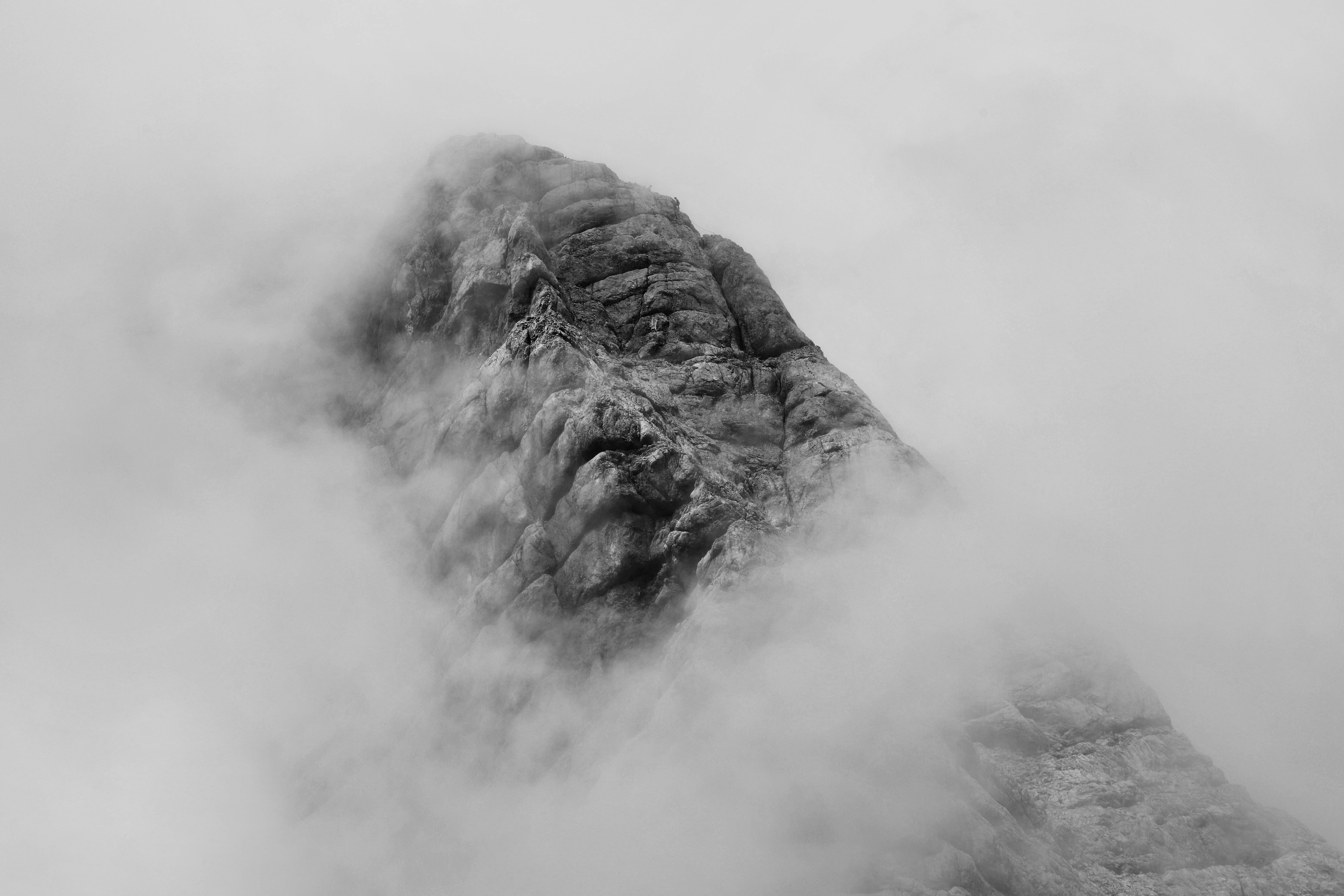 The mountain peak is shrouded in fog, only the outline of the mountain peak is vaguely visible. - free wallpaper image