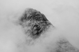 The mountain peak is shrouded in fog, only the outline of the mountain peak is vaguely visible. - free wallpaper image