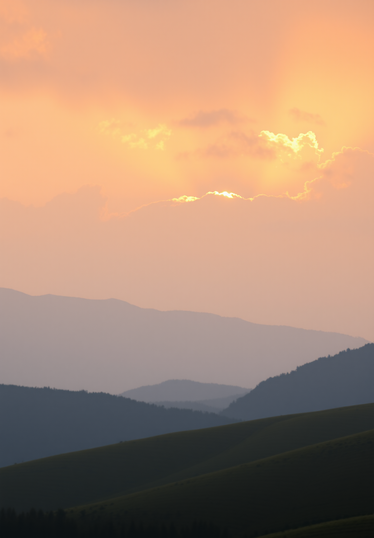 The sun sets over the mountains, the sky is tinged with orange, and the clouds are glowing gold. - wallpaper image