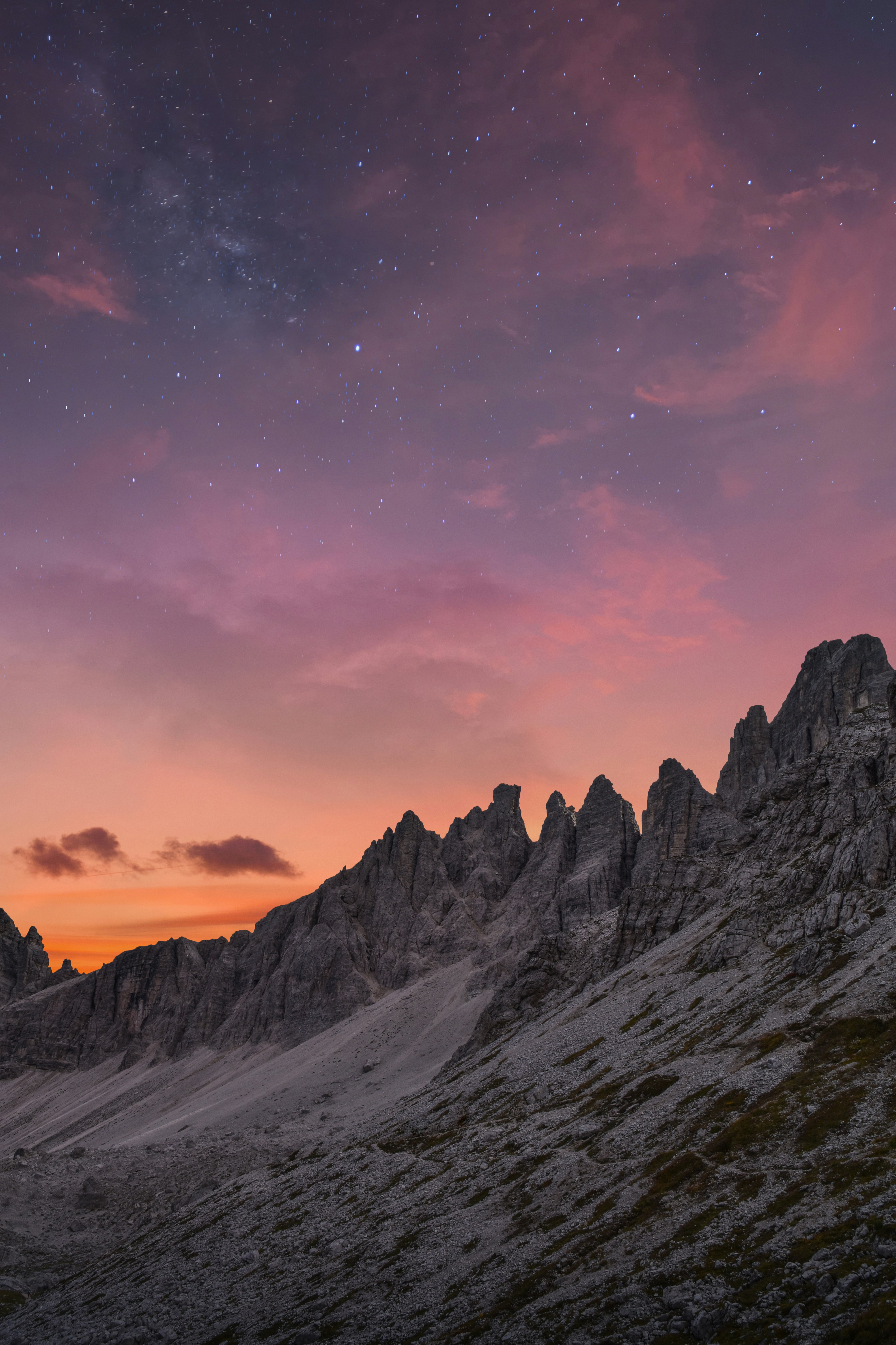 A starry sky with a silhouette of mountains against the setting sun creates a peaceful and serene scene. - free wallpaper image