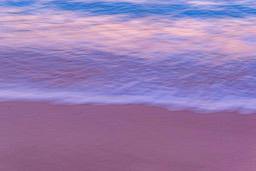 Pink sand beach with blue waves and sky color gradient from blue to pink, it looks like an evening scene. - free wallpaper image