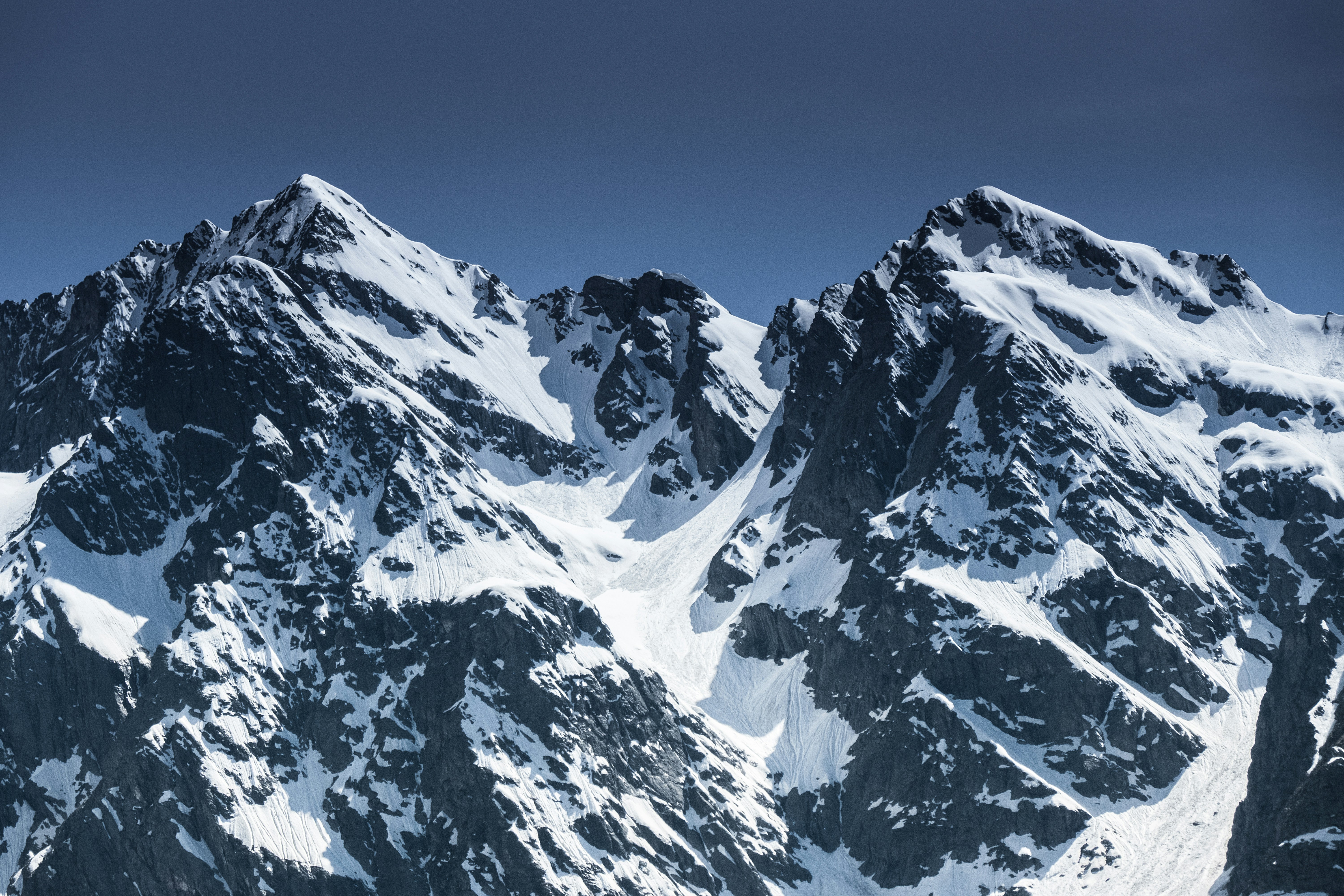 Snow-capped mountain peaks, majestic and spectacular. - free wallpaper image