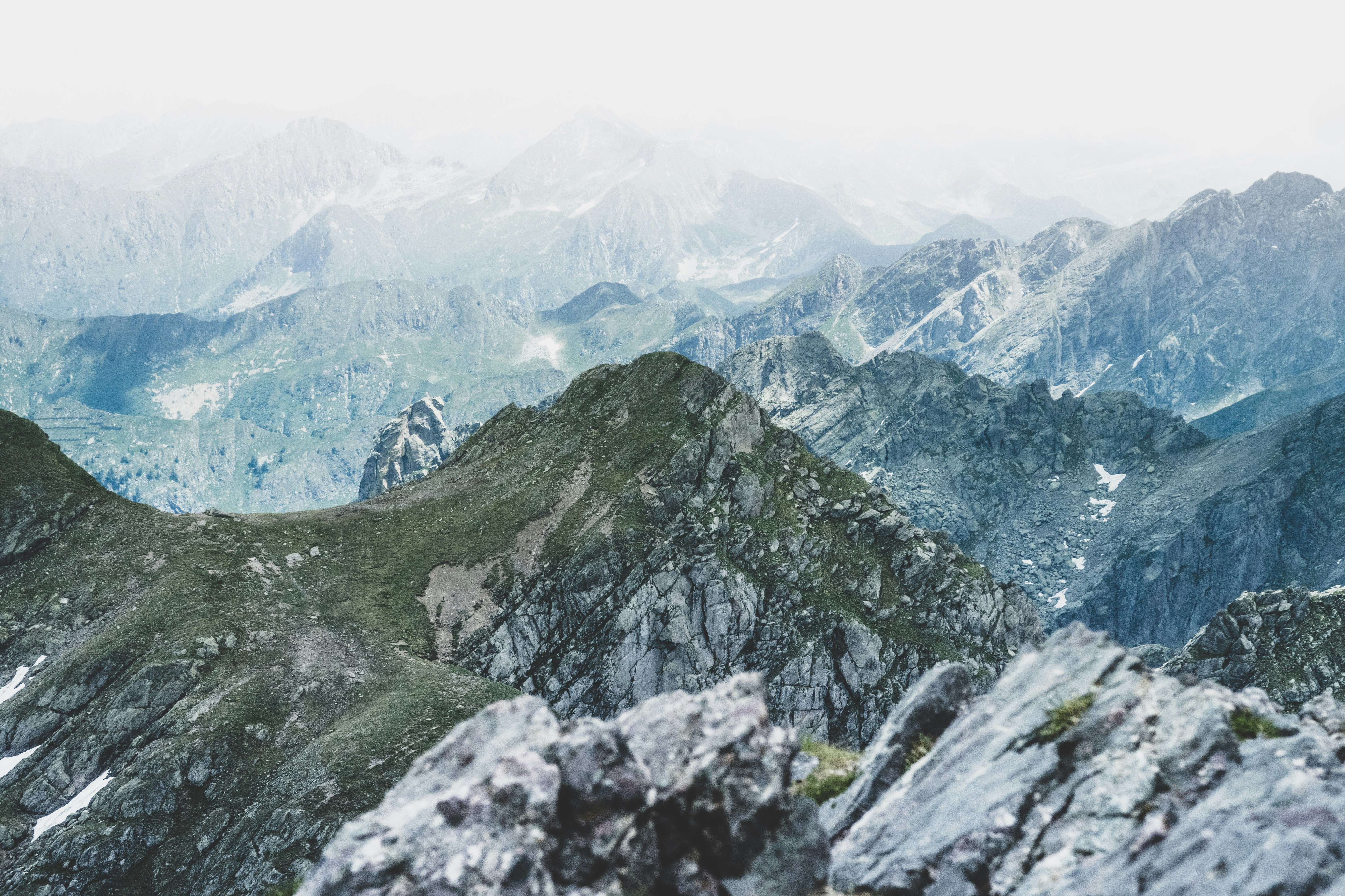 The mountains are rolling and covered with snow, the distant mountains are looming in the mist. - free wallpaper image