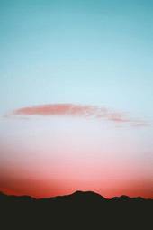 The sun sets in the west, the clouds in the sky are pink and red, and the silhouette of the mountains sets off the beautiful sunset. - free wallpaper image