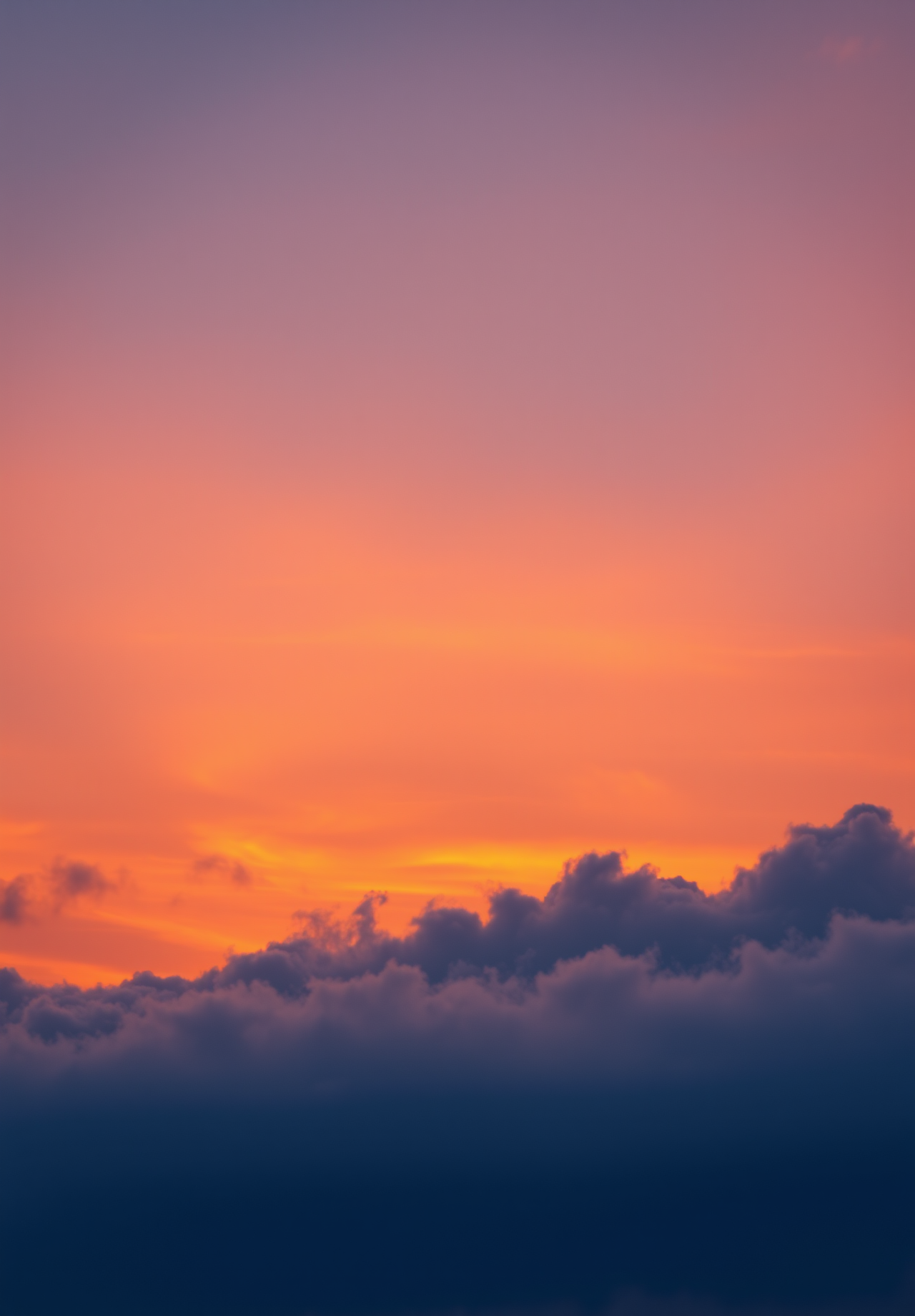 The sunset paints the sky in shades of orange, purple and blue, with clouds taking on a warm hue. - wallpaper image